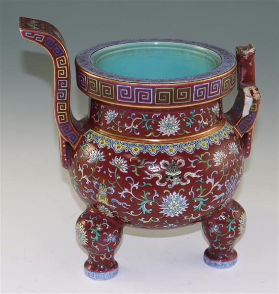 A Chinese famille rose ruby ground tripod censer, Jiaqing six character seal mark and of the period (1796-1820), height 27cm, damage an